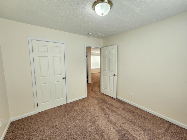 2521 Bonnie Mae Rd, Harrison, MI 48625 - unfurnished bedroom with carpet floors, baseboards, and a textured ceiling