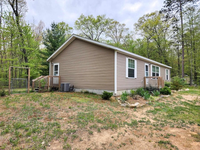 2521 Bonnie Mae Rd, Harrison, MI 48625 - view of property exterior with a deck and central air condition unit