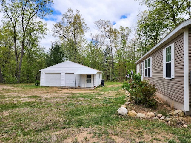 2521 Bonnie Mae Rd, Harrison, MI 48625 - view of yard featuring a garage and an outbuilding