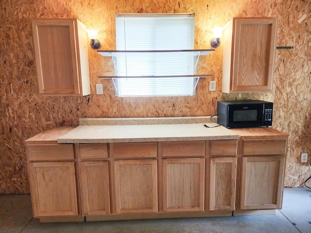 2521 Bonnie Mae Rd, Harrison, MI 48625 - kitchen with black microwave and light brown cabinetry