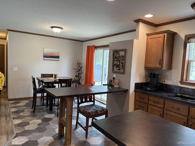245 Silver Creek Rd, Marquette, MI 49855 - dining area featuring crown molding, tile patterned floors, recessed lighting, baseboards, and a textured ceiling