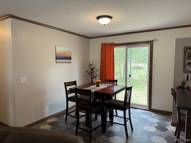 245 Silver Creek Rd, Marquette, MI 49855 - dining space featuring dark floors, baseboards, a textured ceiling, and ornamental molding