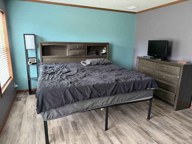 245 Silver Creek Rd, Marquette, MI 49855 - bedroom with wood finished floors, crown molding, baseboards, and a textured ceiling