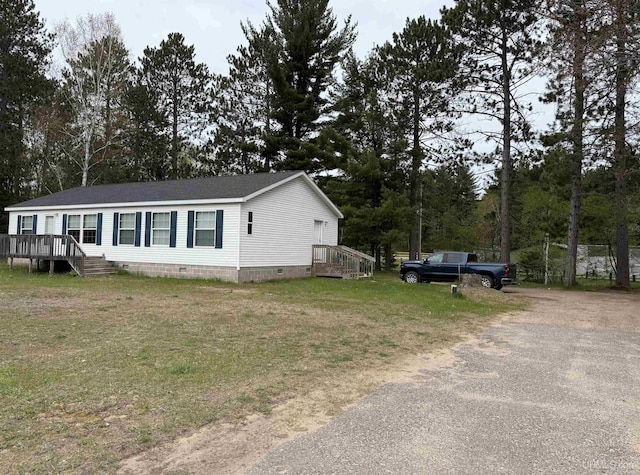 245 Silver Creek Rd, Marquette, MI 49855 - view of front of property featuring crawl space, asphalt driveway, a front yard, a shingled roof, and view of wooded area