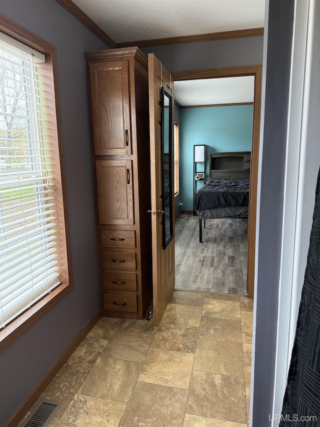 245 Silver Creek Rd, Marquette, MI 49855 - corridor with ornamental molding, baseboards, and light stone finish flooring