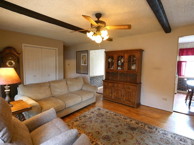 50 Baltic Ave, South Range, MI 49963 - living area featuring a ceiling fan, wood finished floors, and beamed ceiling