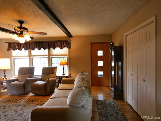 50 Baltic Ave, South Range, MI 49963 - living room featuring a textured ceiling, wood finished floors, a ceiling fan, and beam ceiling