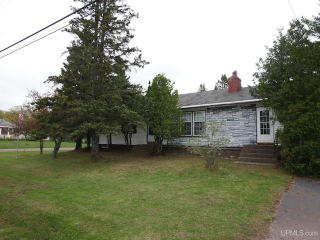 50 Baltic Ave, South Range, MI 49963 - view of front of property featuring a front lawn, stone siding, a chimney, and entry steps