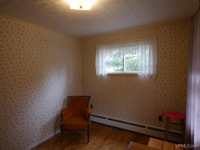 50 Baltic Ave, South Range, MI 49963 - sitting room featuring wood finished floors, a baseboard radiator, crown molding, and wallpapered walls