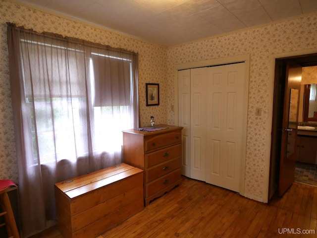 50 Baltic Ave, South Range, MI 49963 - bedroom featuring hardwood / wood-style flooring, wallpapered walls, and a closet