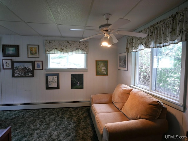 50 Baltic Ave, South Range, MI 49963 - carpeted living room featuring baseboard heating, a ceiling fan, and a drop ceiling