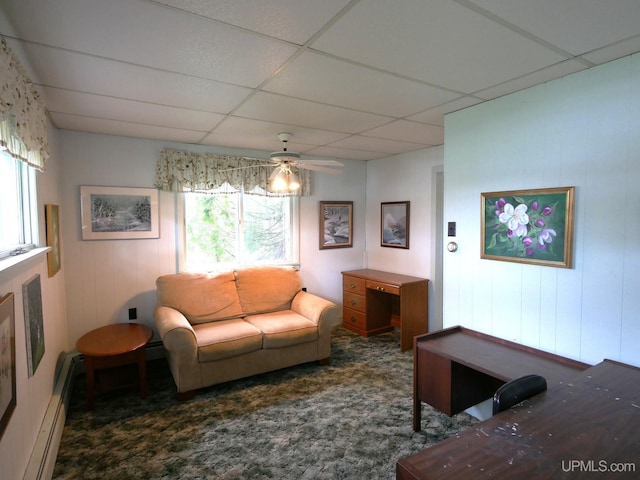 50 Baltic Ave, South Range, MI 49963 - carpeted living area featuring a baseboard heating unit, a ceiling fan, and a drop ceiling