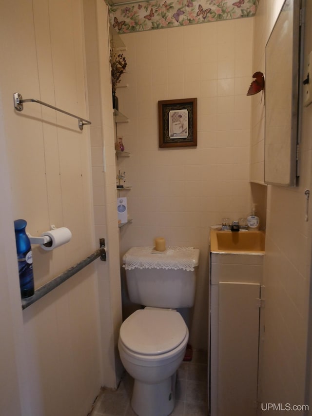 50 Baltic Ave, South Range, MI 49963 - half bathroom with toilet, tile patterned flooring, tile walls, and vanity