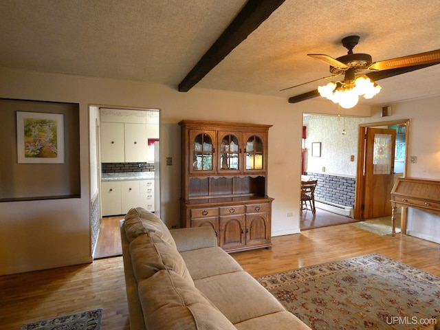 50 Baltic Ave, South Range, MI 49963 - living room featuring a ceiling fan, light wood-type flooring, beamed ceiling, baseboard heating, and a textured ceiling