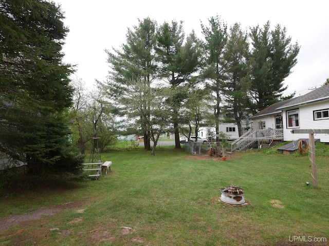 50 Baltic Ave, South Range, MI 49963 - view of grassy yard featuring an outdoor fire pit and a deck