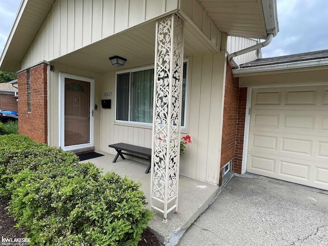 11527 Crown Dr, Sterling Heights, MI 48314 - view of exterior entry featuring a porch and brick siding