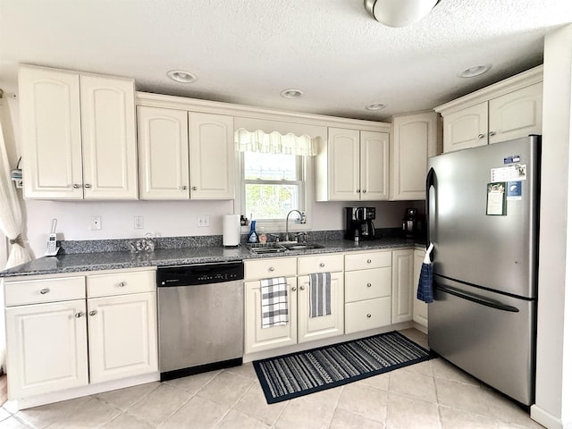 2684 Lakeshore Dr, Gladwin, MI 48624 - kitchen featuring stainless steel appliances, a sink, dark countertops, white cabinetry, and recessed lighting