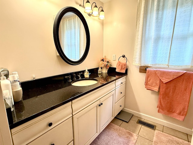 2684 Lakeshore Dr, Gladwin, MI 48624 - bathroom with vanity, tile patterned flooring, and baseboards
