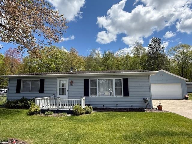 2684 Lakeshore Dr, Gladwin, MI 48624 - ranch-style house featuring a garage, a front yard, concrete driveway, and an outdoor structure