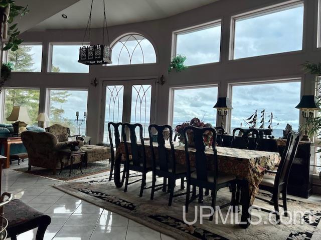 9411 Goodell Rd, Eagle Harbor, MI 49950 - dining area featuring a high ceiling and light marble finish floors