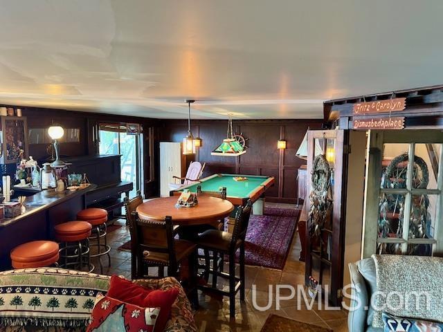 9411 Goodell Rd, Eagle Harbor, MI 49950 - dining room featuring billiards, tile patterned floors, and wooden walls