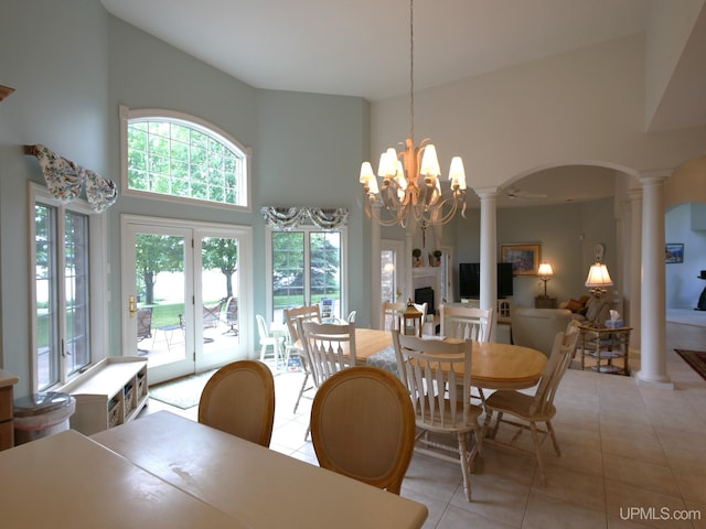 52765 Bootjack Rd, Lake Linden, MI 49945 - dining space featuring decorative columns, a high ceiling, light tile patterned flooring, arched walkways, and a chandelier
