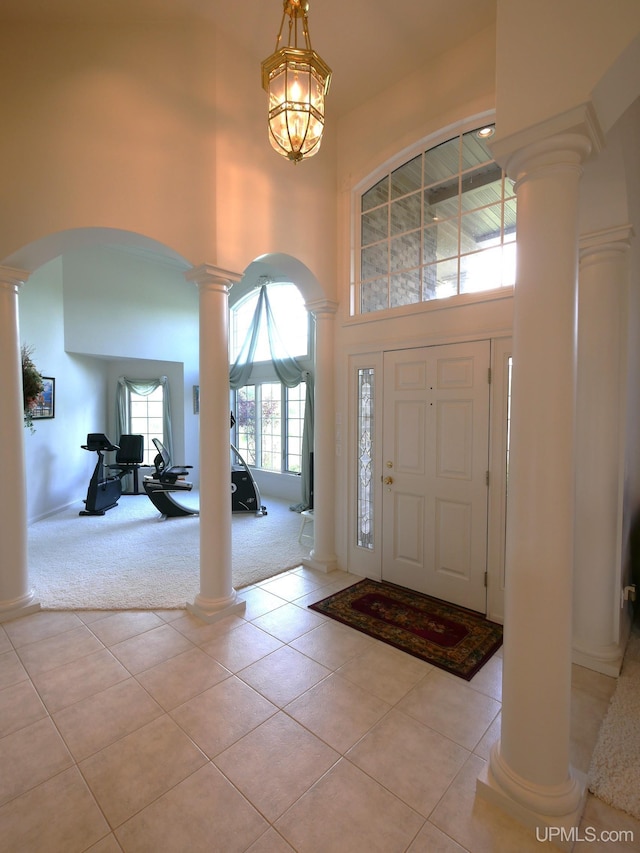 52765 Bootjack Rd, Lake Linden, MI 49945 - foyer entrance with ornate columns, a towering ceiling, arched walkways, light carpet, and light tile patterned floors