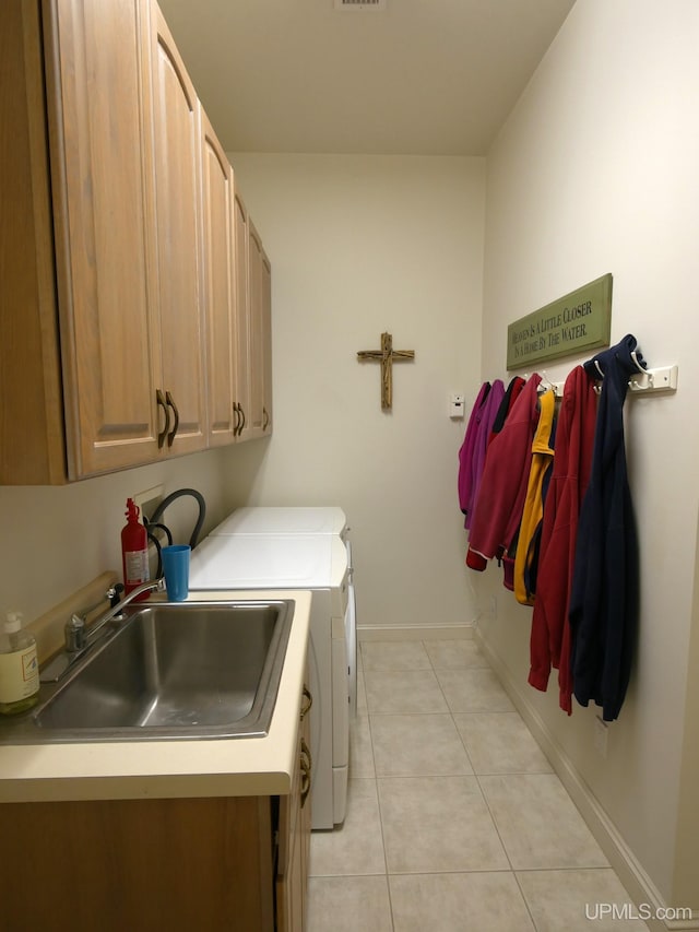 52765 Bootjack Rd, Lake Linden, MI 49945 - laundry room with cabinet space, washer and dryer, light tile patterned floors, and baseboards
