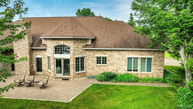 52765 Bootjack Rd, Lake Linden, MI 49945 - rear view of property featuring a lawn, a patio area, brick siding, and roof with shingles