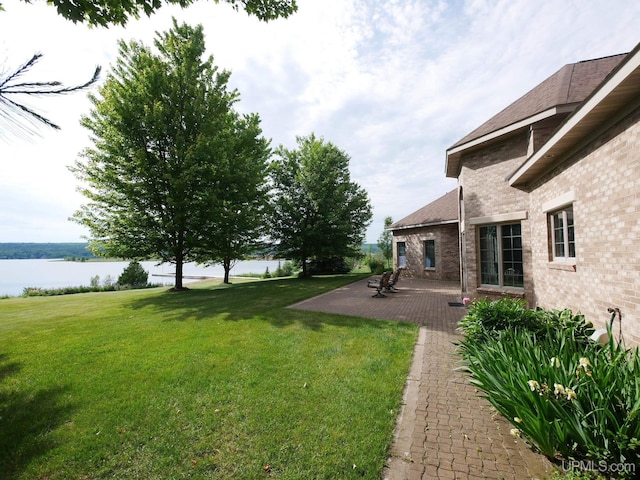 52765 Bootjack Rd, Lake Linden, MI 49945 - view of green lawn with a water view and a patio area