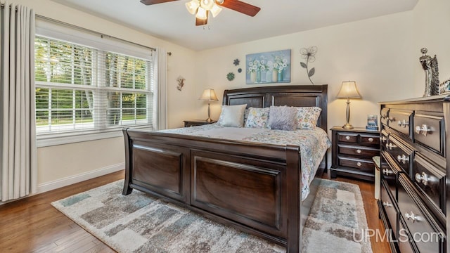 6376 Marie L.45 Ln, Escanaba, MI 49829 - bedroom with wood finished floors, baseboards, and a ceiling fan