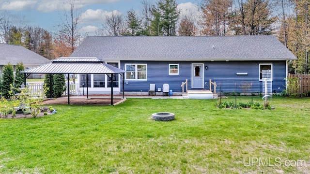 6376 Marie L.45 Ln, Escanaba, MI 49829 - rear view of house featuring a gazebo, a fire pit, and a shingled roof
