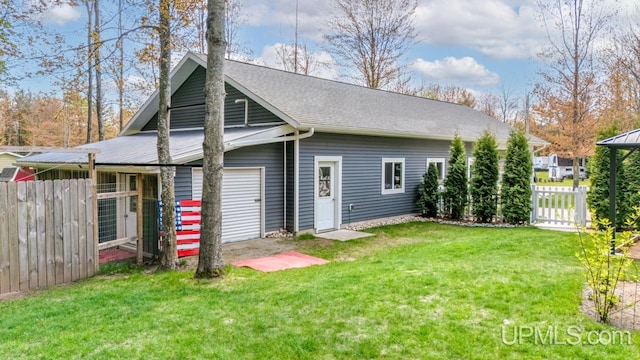 6376 Marie L.45 Ln, Escanaba, MI 49829 - back of house with a detached garage and roof with shingles