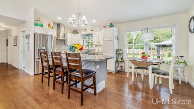6376 Marie L.45 Ln, Escanaba, MI 49829 - kitchen with wall chimney exhaust hood, stainless steel refrigerator with ice dispenser, a chandelier, white cabinetry, and recessed lighting