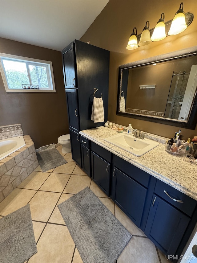59 Forest Dr, Negaunee, MI 49866 - full bath with vanity, a bath, tile patterned floors, and toilet