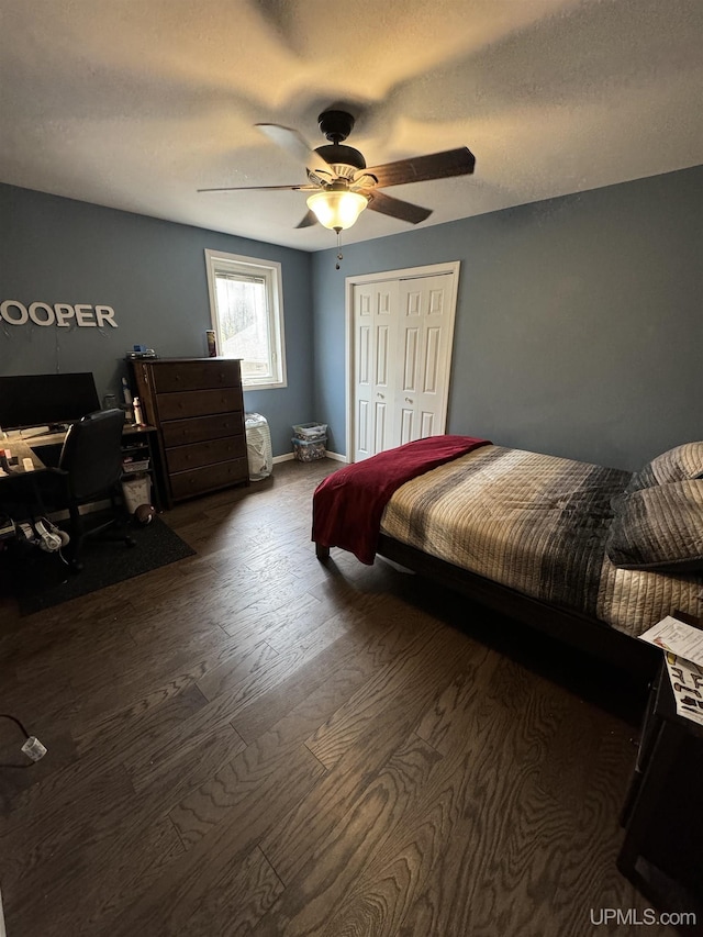 59 Forest Dr, Negaunee, MI 49866 - bedroom featuring wood finished floors, a closet, an office area, ceiling fan, and baseboards