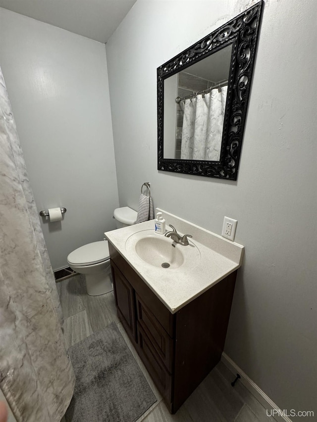 59 Forest Dr, Negaunee, MI 49866 - full bath featuring vanity, toilet, and baseboards