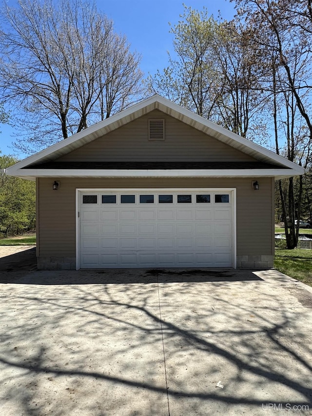 59 Forest Dr, Negaunee, MI 49866 - view of home's exterior with an outdoor structure and a garage