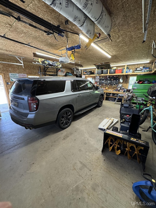 59 Forest Dr, Negaunee, MI 49866 - garage featuring a garage door opener and a workshop area