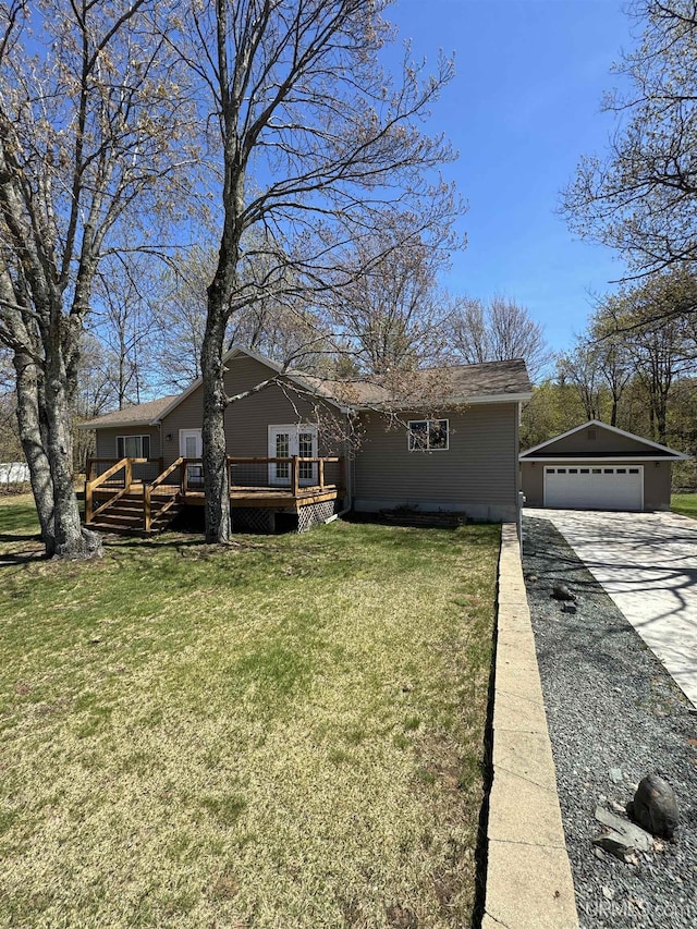 59 Forest Dr, Negaunee, MI 49866 - view of front of property with a deck, a garage, an outdoor structure, a front lawn, and concrete driveway
