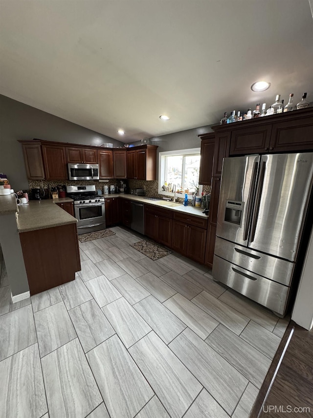 59 Forest Dr, Negaunee, MI 49866 - kitchen featuring stainless steel appliances, backsplash, a sink, lofted ceiling, and recessed lighting