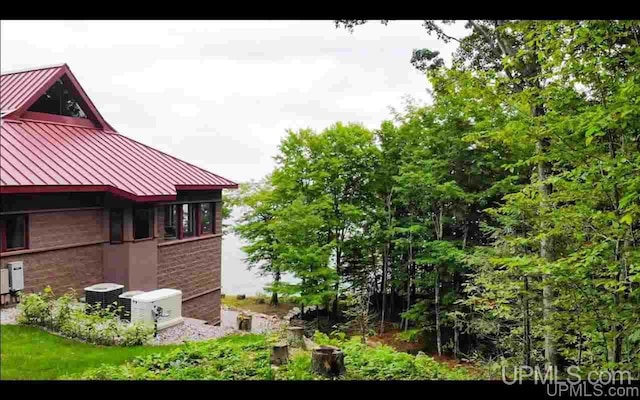 N9910 Shore Dr, Au Train, MI 49806 - view of property exterior with a standing seam roof, metal roof, and brick siding