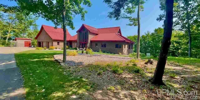 N9910 Shore Dr, Au Train, MI 49806 - view of front of house with metal roof and a front yard