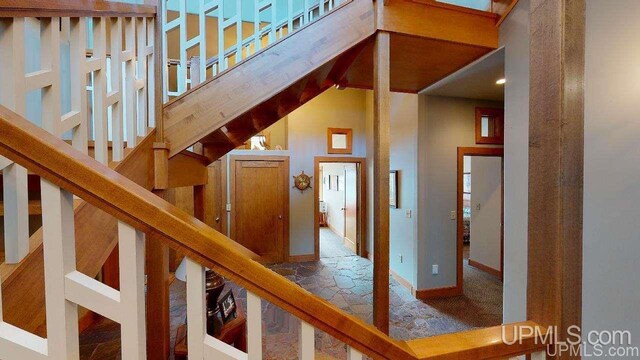 N9910 Shore Dr, Au Train, MI 49806 - staircase with stone tile flooring and baseboards