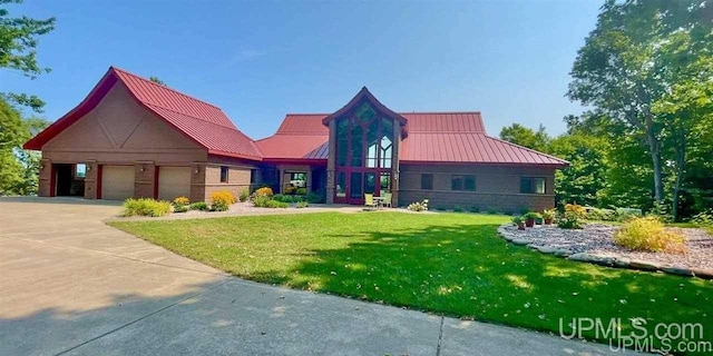 N9910 Shore Dr, Au Train, MI 49806 - modern home with a standing seam roof, a front lawn, metal roof, and driveway