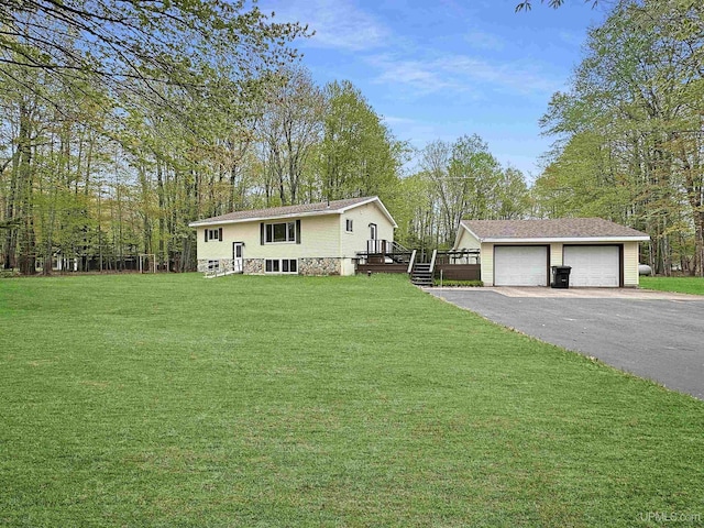 8672 M.5 Rd, Gladstone, MI 49837 - view of front facade with an outdoor structure, a front lawn, a deck, and a detached garage