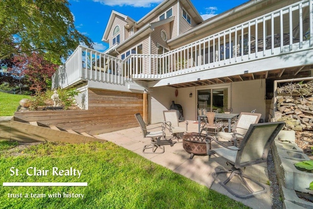 1080 Highland Dr, Saint Clair, MI 48079 - back of property featuring a fire pit, a patio, and a deck