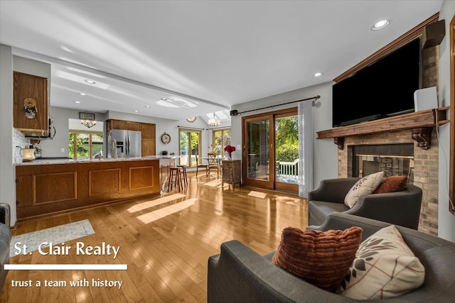 1080 Highland Dr, Saint Clair, MI 48079 - living area with light wood-type flooring, a fireplace, recessed lighting, and a chandelier
