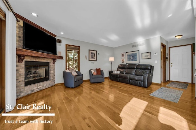 1080 Highland Dr, Saint Clair, MI 48079 - living room featuring wood finished floors, a brick fireplace, baseboards, and recessed lighting