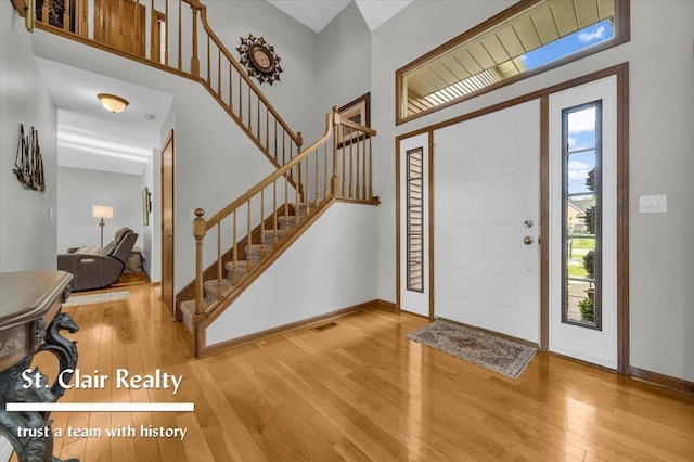 1080 Highland Dr, Saint Clair, MI 48079 - entrance foyer with wood-type flooring, baseboards, stairway, and a high ceiling